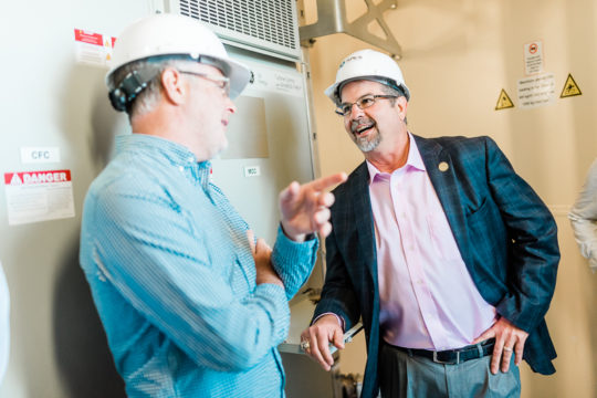 Texas Senator Charles Perry (right) gets a new perspective on wind energy while touring a wind farm in his district.