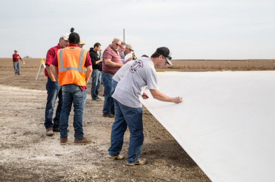 Community members sign a turbine blade to be used in the Hoopeston Wind project in Illinois.