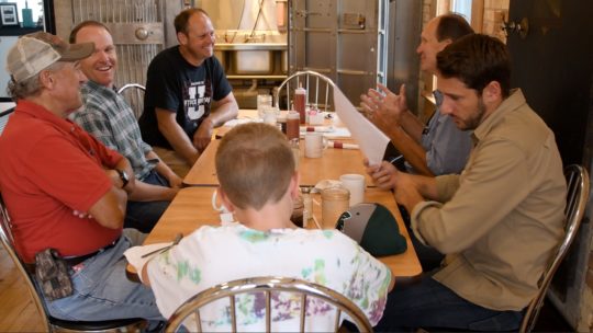 Bob Walton (far left) and the other members of the wind energy steering committee meet with Apex representatives over breakfast at Roz’s Diner in Rosebush, Michigan.