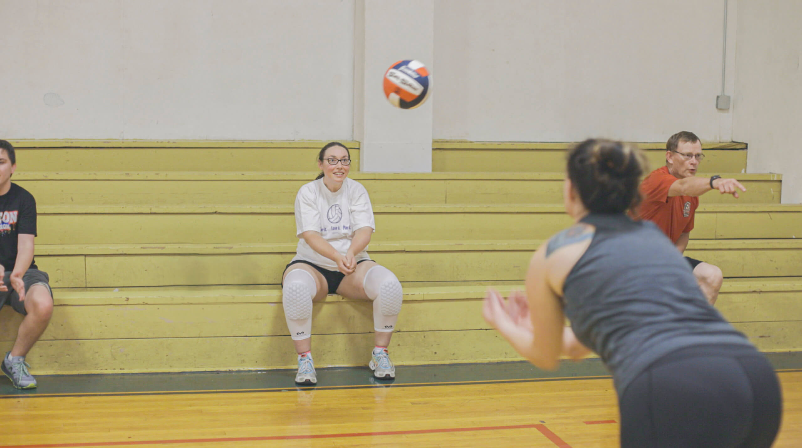 woman seated at volleyball practice