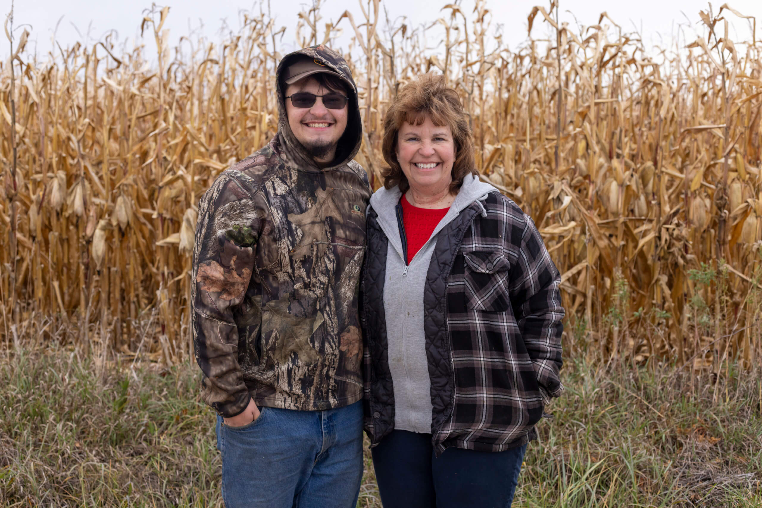 people smiling in cornfield