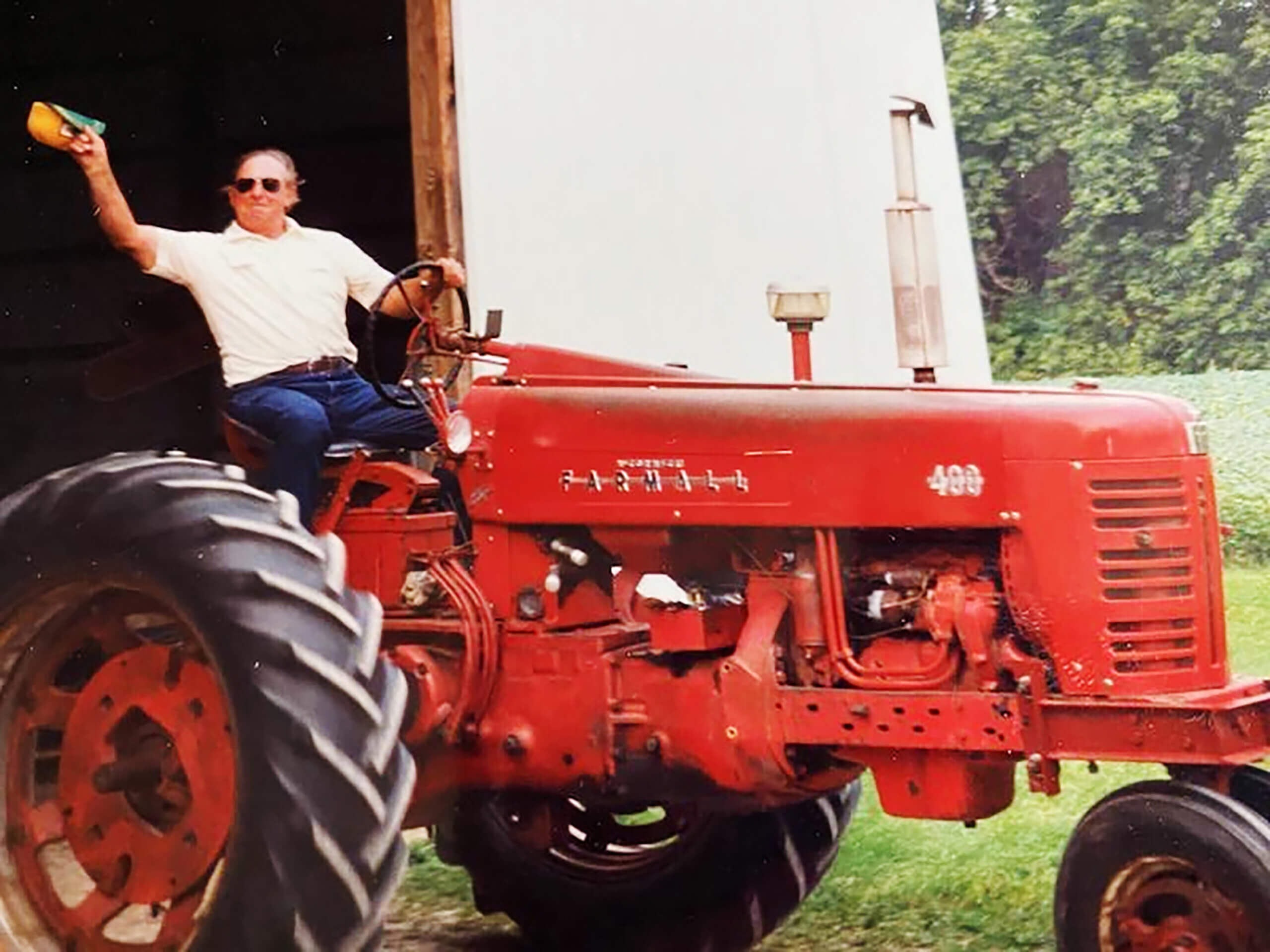 man waving on tractor