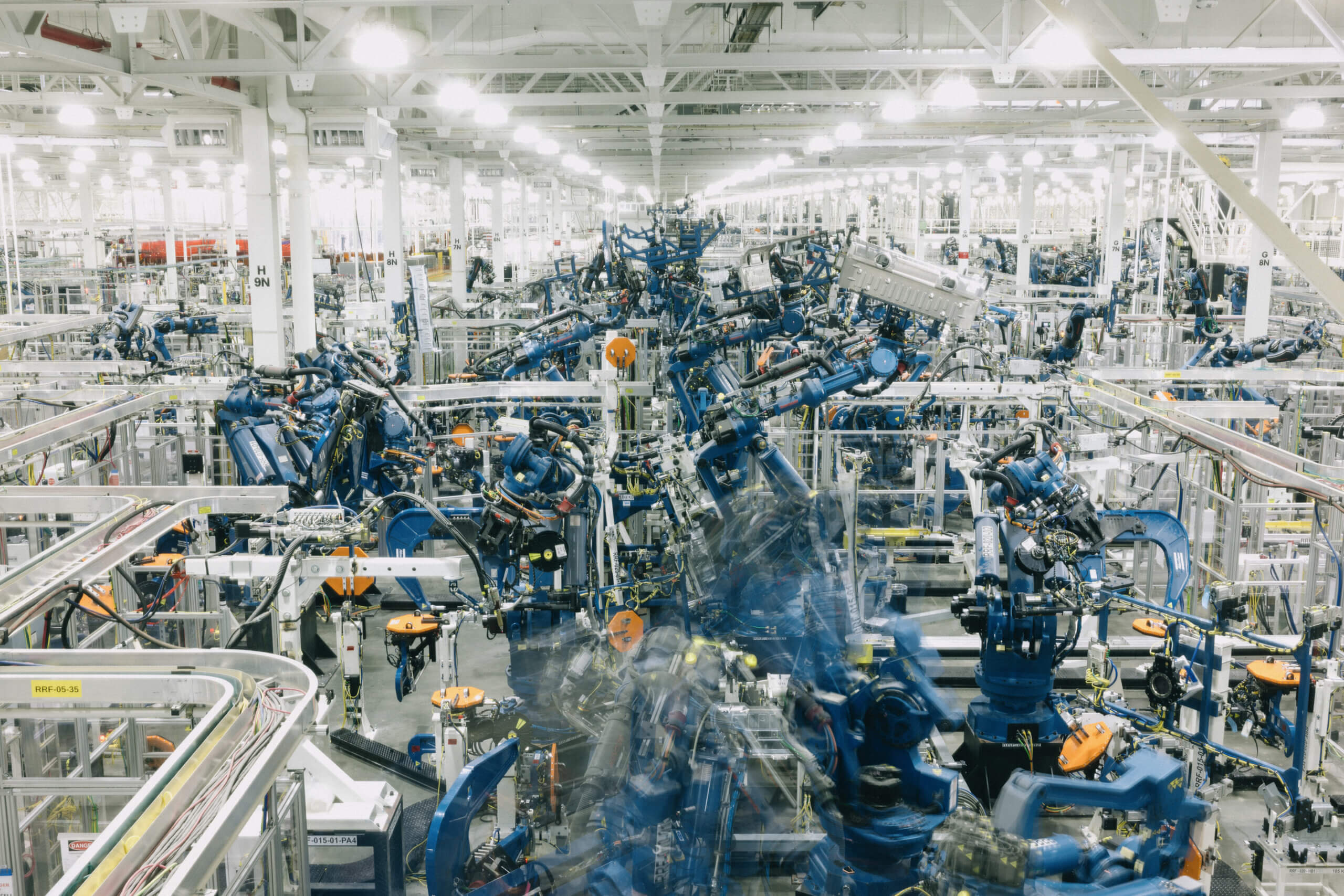 robots building cars in factory