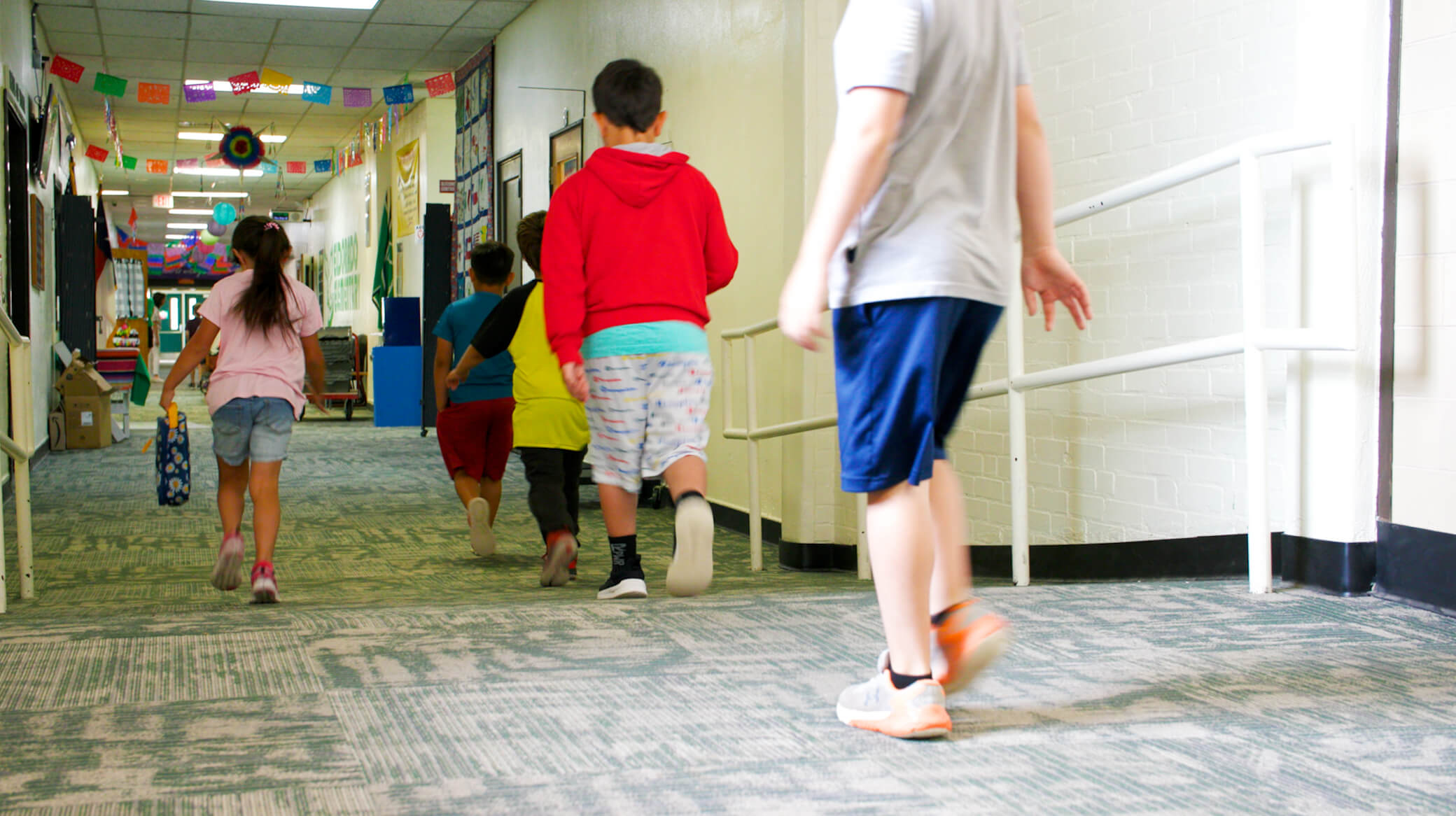 kids walking down school hallway