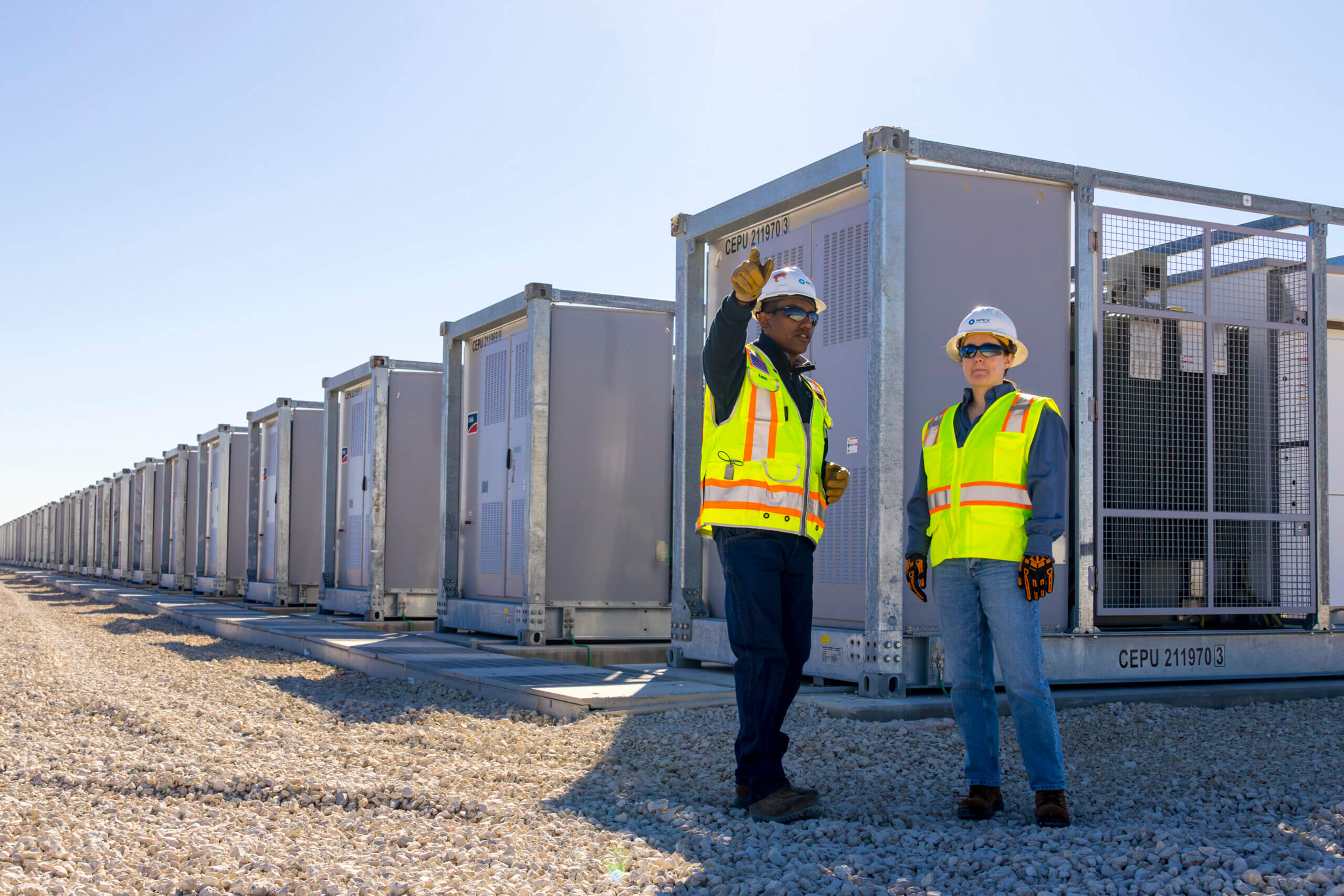 man and woman in construction gear at a battery storage facility
